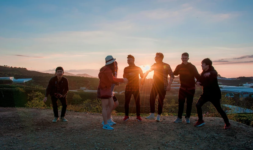 a group of people standing on top of a dirt field, sunset in a valley, profile image, sport, behind the scenes photo