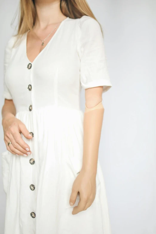 a woman in a white dress posing for a picture, bandage on arms, white background : 3, model photograph, buttons
