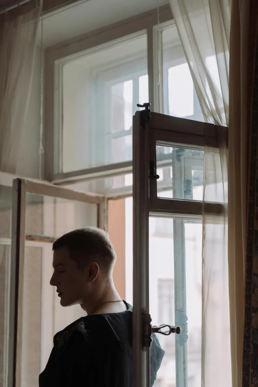 a man that is standing in front of a window, a picture, inspired by Elsa Bleda, unsplash, vitalik buterin, he is about 20 years old | short, still from film, pavel shvedov