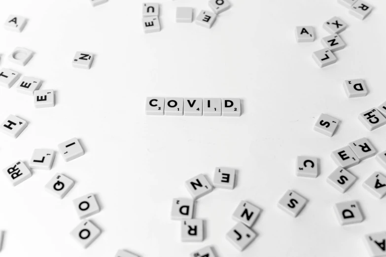 a circle of scrabbles with the word covid written on them, a black and white photo, by Raphaël Collin, pexels, white minimalistic background, background image, cavities, void 1a