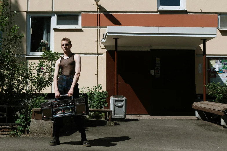 a woman holding two suitcases in front of a building, an album cover, by Attila Meszlenyi, pexels contest winner, vitalik buterin, nonbinary model, in front of the house, egor letov