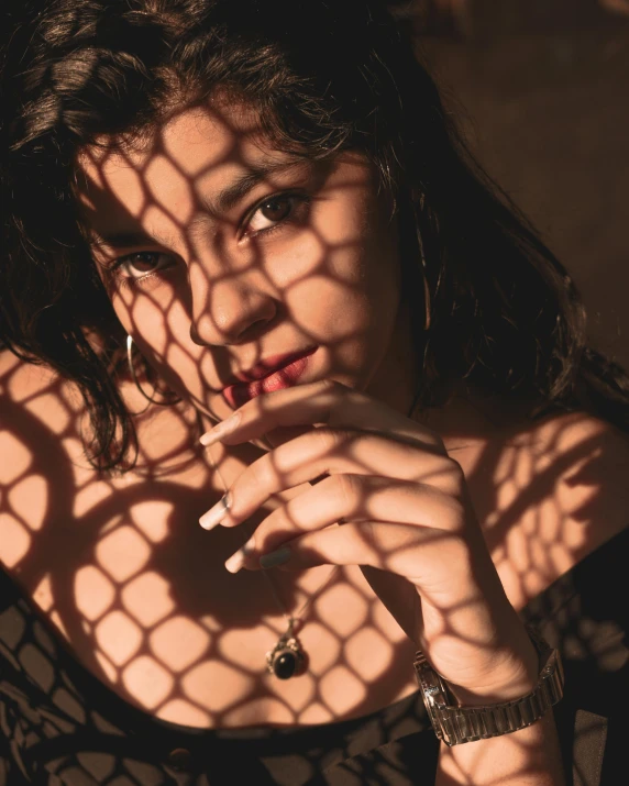 a close up of a person holding a cigarette, an album cover, inspired by Elsa Bleda, trending on pexels, beautiful mexican woman, stood in a cell, sun dappled, 🤤 girl portrait