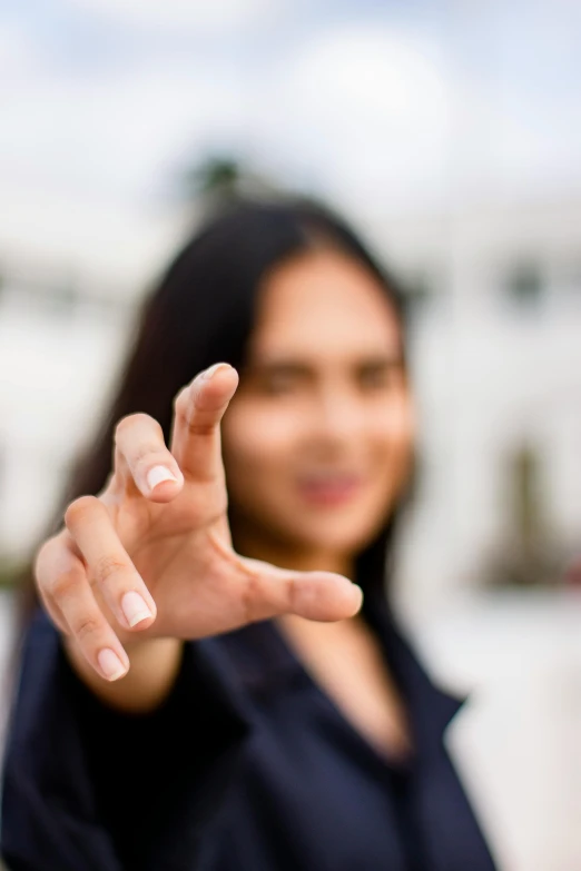 a woman making a stop sign with her hand, a picture, by Julian Allen, square, out - of - focus background, your personal data avatar, asian women