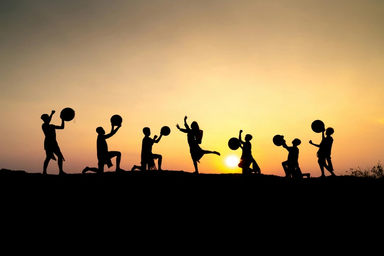 a group of people standing on top of a hill, by Michael Goldberg, pexels contest winner, figuration libre, lifting weights, silhouette over sunset, football, various posed