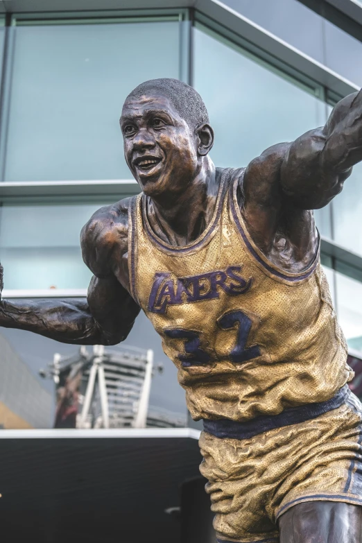 a statue of a man holding a basketball ball, draped in silky purple and gold, excitement, foreground background, 🚿🗝📝