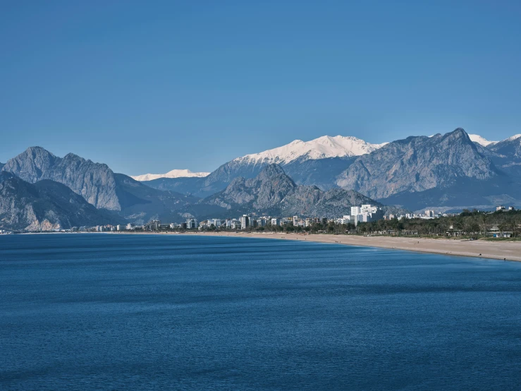 a body of water with mountains in the background, by Carlo Martini, pexels contest winner, hurufiyya, marbella, turkey, blue: 0.25, multiple stories