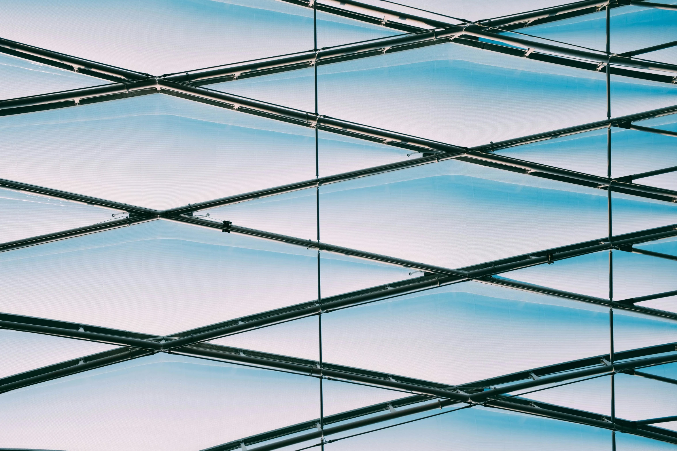 a close up of a glass building with a sky background, inspired by Andreas Gursky, unsplash, square lines, faceted, canopies, blue tinted