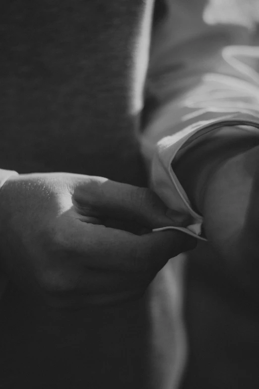 a black and white photo of a person holding a book, hyperrealism, white sleeves, morning detail, uploaded, origami