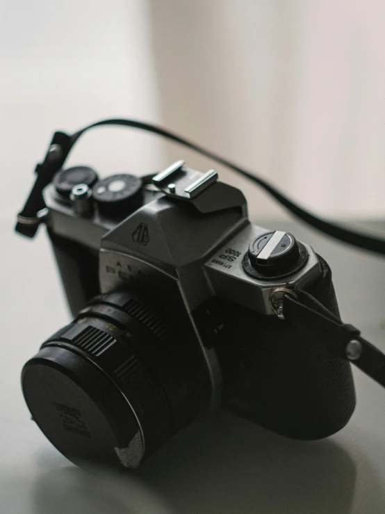 a black camera sitting on top of a table, by Adam Rex, fan favorite, analogue photo low quality, switch, camera flash