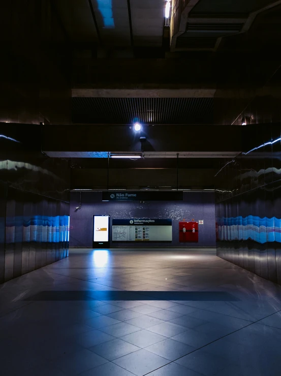 an empty parking garage with blue lights, an album cover, unsplash contest winner, light and space, train station, entrance to a dark tunnel, central station in sydney, high quality photo