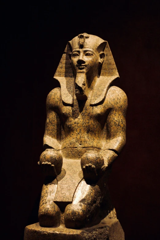 a statue of a man sitting on a rock, egyptian art, wears a egyptian ankh necklace, fine art museum piece, an intricate, tim