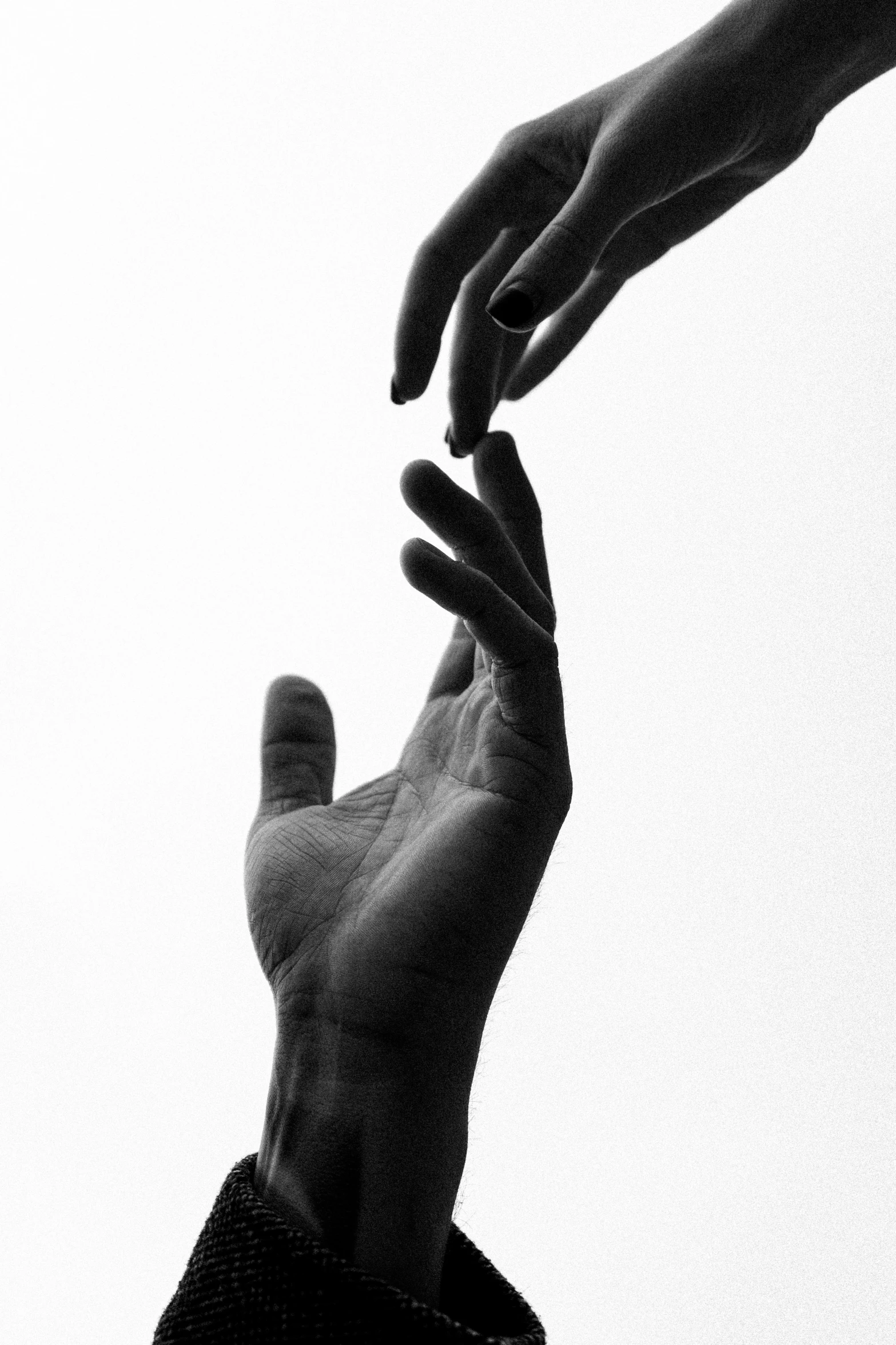 a black and white photo of two hands reaching for something, by Alexis Grimou, unsplash, conceptual art, ffffound, lovers, kaethe butcher, multiple stories