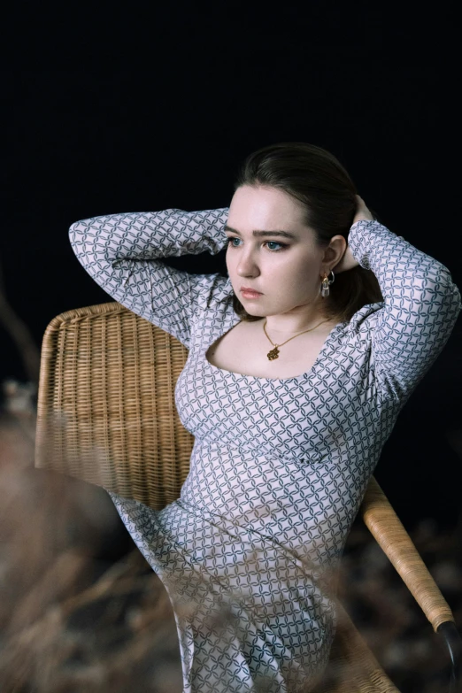 a woman sitting on a wicker chair in a field, an album cover, inspired by Elsa Bleda, unsplash, renaissance, dilraba dilmurat, alluring plus sized model, wearing a sweater, patterned clothing