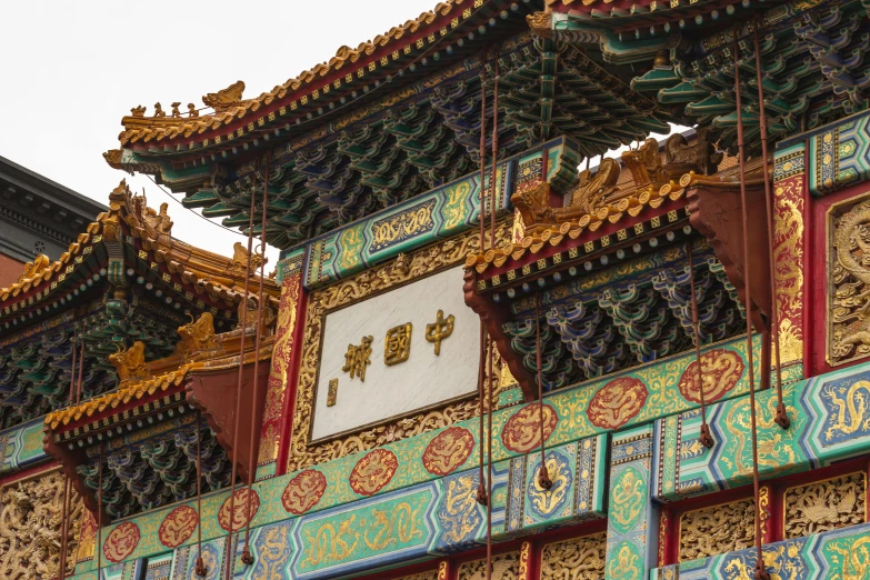 a close up of a building with a clock on it, a detailed painting, inspired by An Zhengwen, trending on unsplash, cloisonnism, square, golden chinese text, multi - coloured, archway