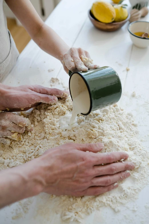 a couple of people that are making some food, with a white mug, plaster, no cropping, yeast