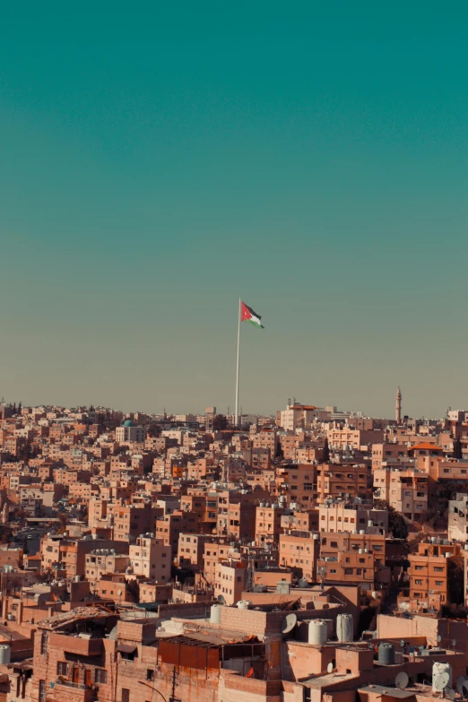 a view of a city from the top of a hill, an album cover, by Ibram Lassaw, trending on unsplash, hurufiyya, jordan, clear sky above, red green, slide show