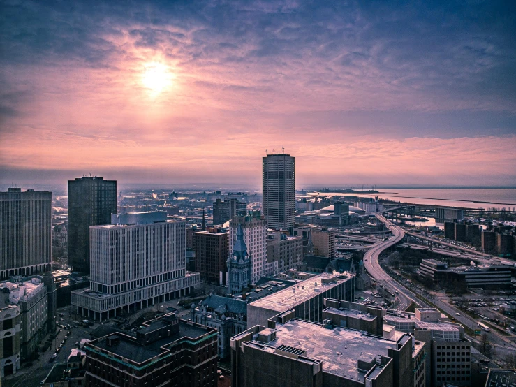 a view of a city from the top of a building, a colorized photo, by Brad Holland, pexels contest winner, winter sun, rhode island, first light, high quality photo