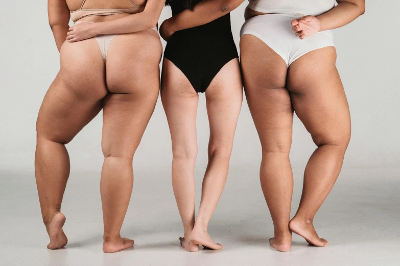 a group of three women standing next to each other, by Matija Jama, trending on pexels, renaissance, round thighs, obese ), her skin is light brown, varying ethnicities