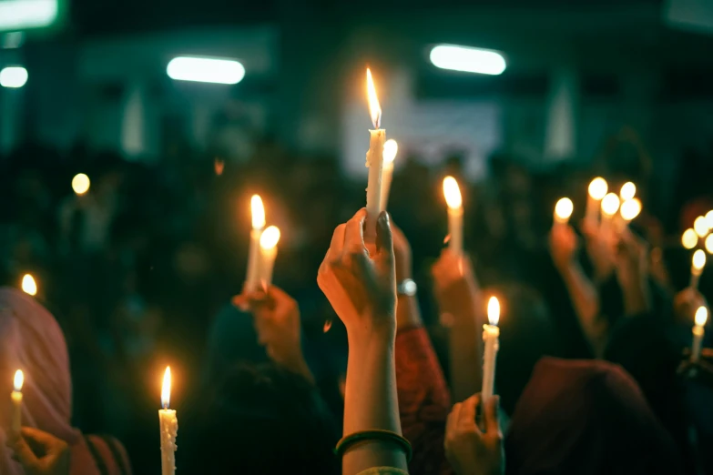 a group of people holding candles in their hands, trending on pexels, brutal violence, instagram post, university, profile pic