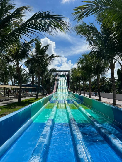 a water slide in the middle of a park, ocean in the background, thumbnail, up close, highly upvoted