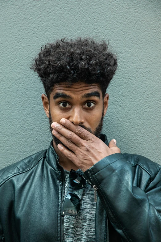 a man in a leather jacket covers his mouth with his hands, by Cosmo Alexander, trending on pexels, renaissance, imaan hammam, grainy photo of an ugly man, surprised frown, diverse haircuts