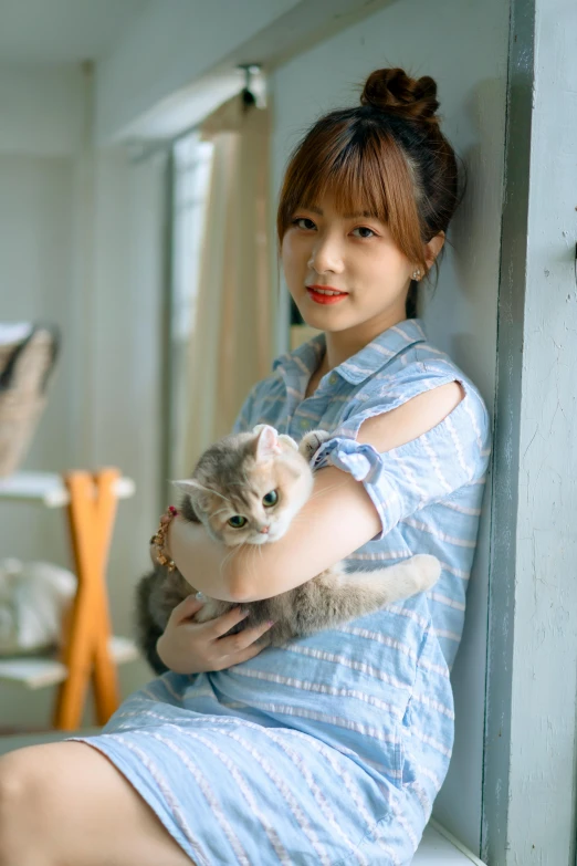 a woman sitting on a window sill holding a cat, a picture, by Tan Ting-pho, pexels contest winner, wan adorable korean face, blue and grey, square, large)}]