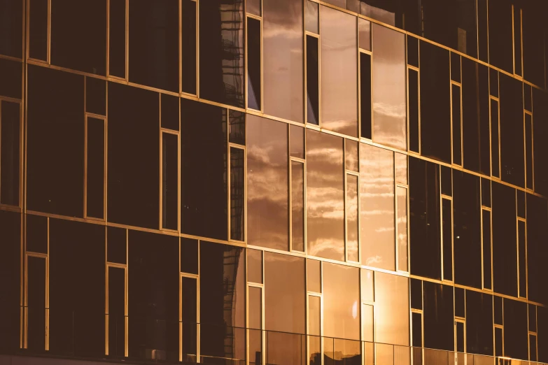 a very tall building with a lot of windows, pexels contest winner, modernism, golden twilight stained glass, reflections in copper, gold and black, desktop wallpaper