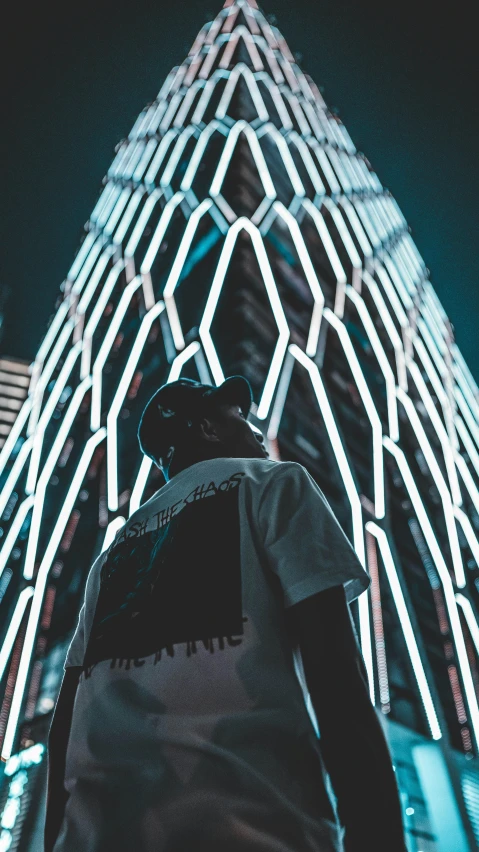 a person standing in front of a tall building, unsplash contest winner, afrofuturism, white neon lights, trending on r/streetwear, abduzeedo, facing sideways