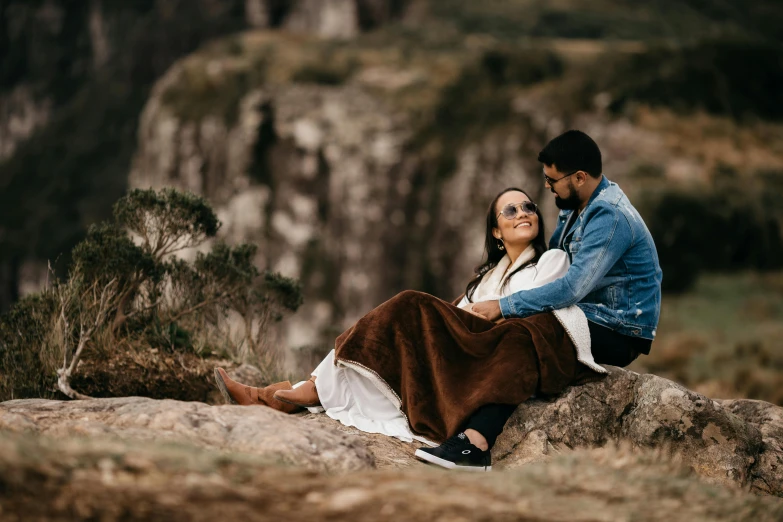 a man and woman sitting on top of a rock, a picture, by Lee Loughridge, pexels contest winner, sydney park, gorgeous lady, thumbnail, romantic themed