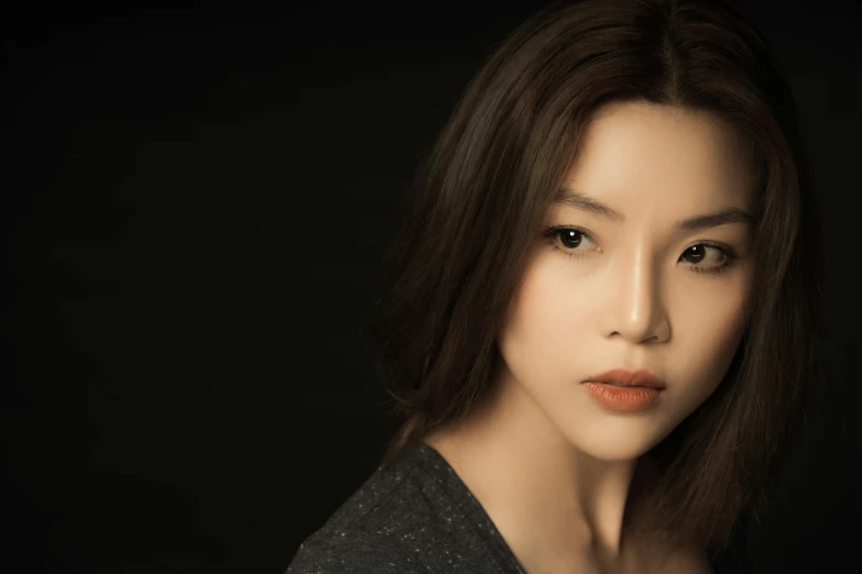 a woman standing in front of a black background, a character portrait, inspired by Wen Jia, pexels contest winner, photorealism, cute korean actress, immaculate complexion, on a gray background, ethnicity : japanese