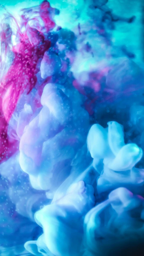 a blue and pink liquid is in the water, a microscopic photo, inspired by Kim Keever, unsplash, made of cotton candy, synesthesia, video, space clouds