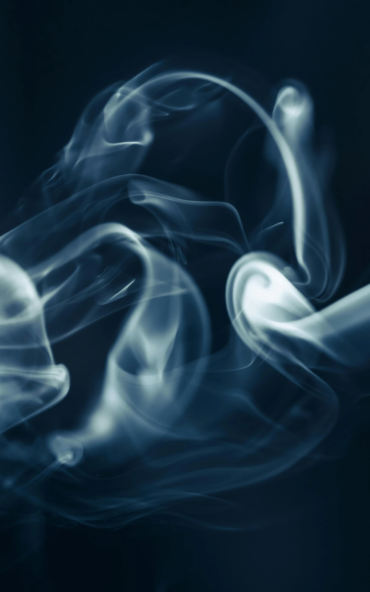 a close up of smoke on a black background, an album cover, pexels, light blues, swirly, praying with tobacco, desaturated blue