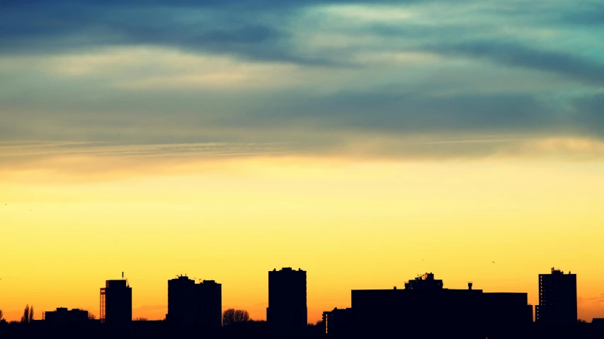 a plane flying over a city at sunset, inspired by Elsa Bleda, pexels contest winner, minimalism, three towers, silhouette :7, :: morning, winnipeg skyline