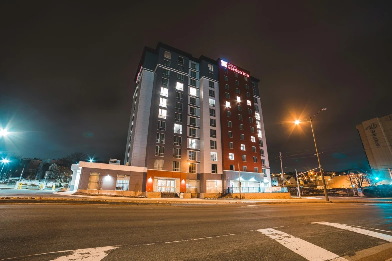 a tall building sitting on the side of a road, by Washington Allston, hotel room, red and white lighting, neo norilsk, thumbnail