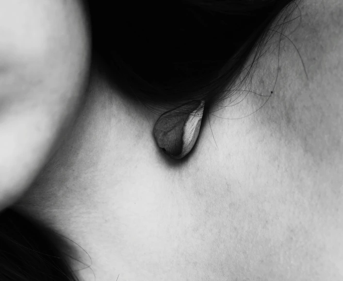 a black and white photo of a woman's ear, inspired by Taro Yamamoto, hurufiyya, small necklace, bleeding, chrysalis, awww
