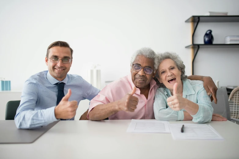 two men and a woman sitting at a table giving thumbs up, pexels contest winner, elderly, professional work, frail, varying ethnicities