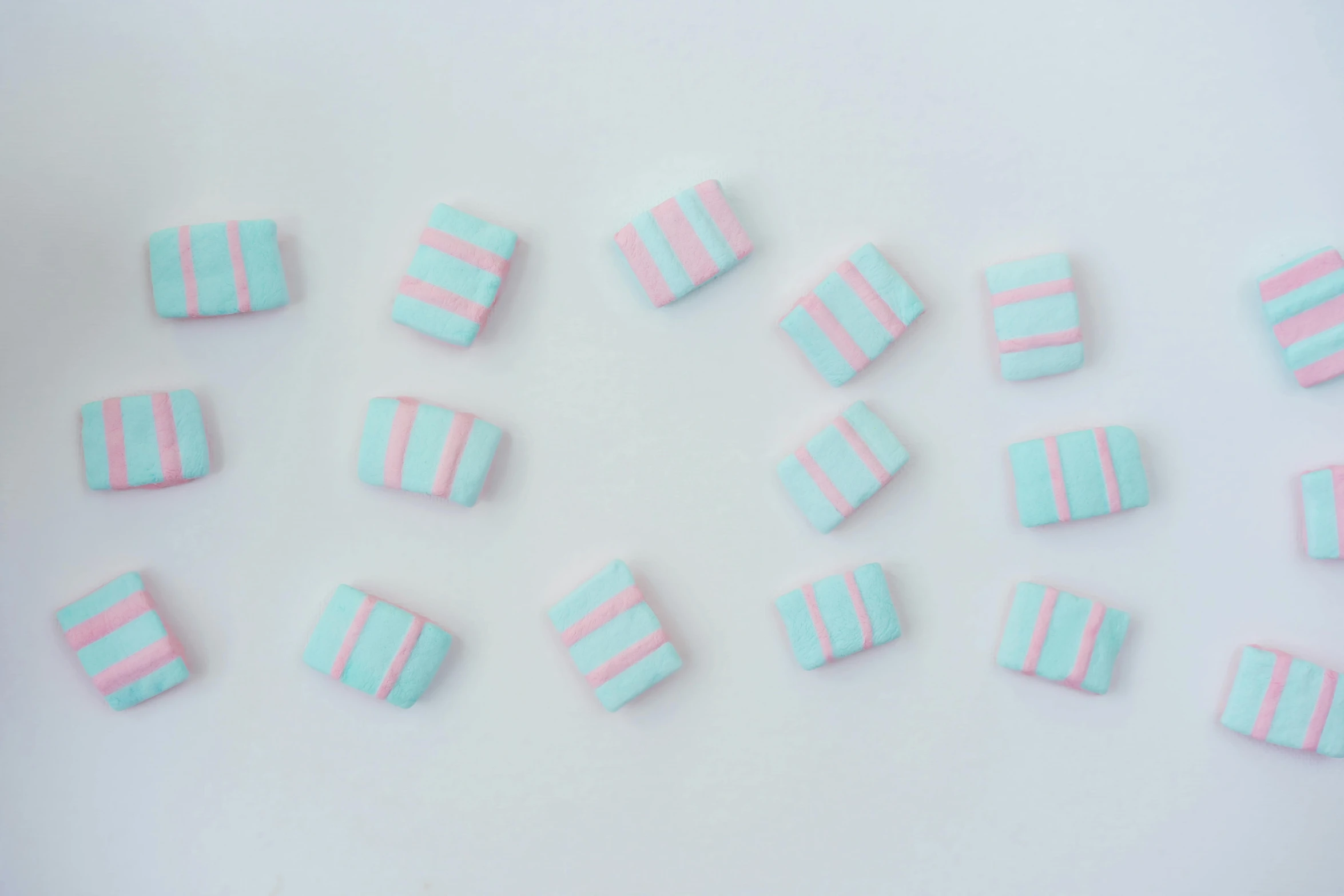 a white plate topped with lots of pink and blue candies, by Emma Andijewska, unsplash, cubic blocks stripes, simple minimal, turquoise jewelry, felt