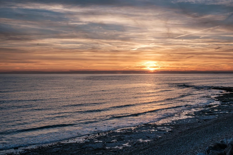 a large body of water next to a beach, by Andrew Allan, pexels contest winner, romanticism, ((sunset)), checkerboard horizon, grey, brown