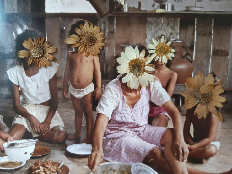 a group of people sitting around a table with plates of food, by Lucia Peka, pexels contest winner, hyperrealism, flower mask, 1970s philippines, 1990's photo, brown flowers