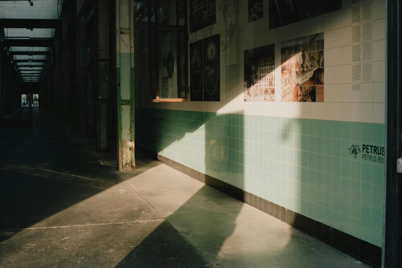 the sun shines through the windows of a building, a polaroid photo, inspired by Elsa Bleda, light and space, stood outside a corner shop, long cast shadows, pale green backlit glow, in a subway