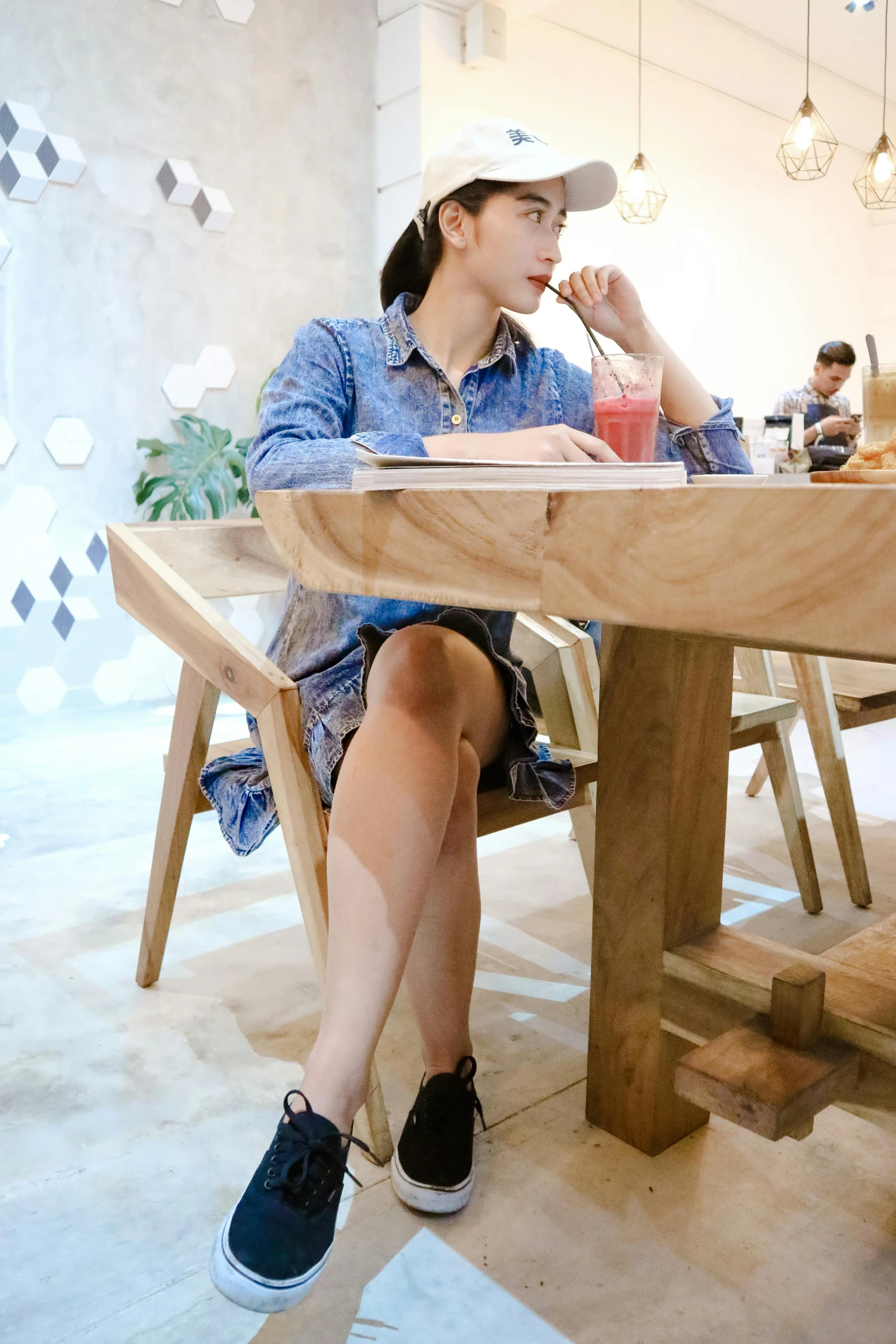 a woman sitting at a table with a drink in her hand, by Hirosada II, unsplash, full body xianxia, jakarta, 15081959 21121991 01012000 4k, crossed legs
