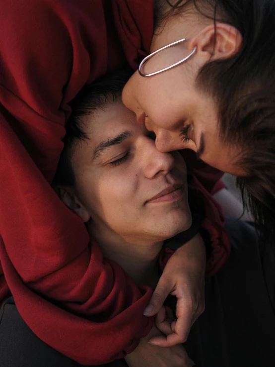 a couple of people laying on top of each other, trending on unsplash, romanticism, he‘s wearing a red neckerchief, lesbian, wearing hoodie, supportive