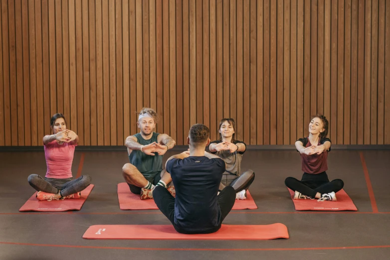 a group of people sitting on top of a red mat, stretch, avatar image, max prentis, upper body image