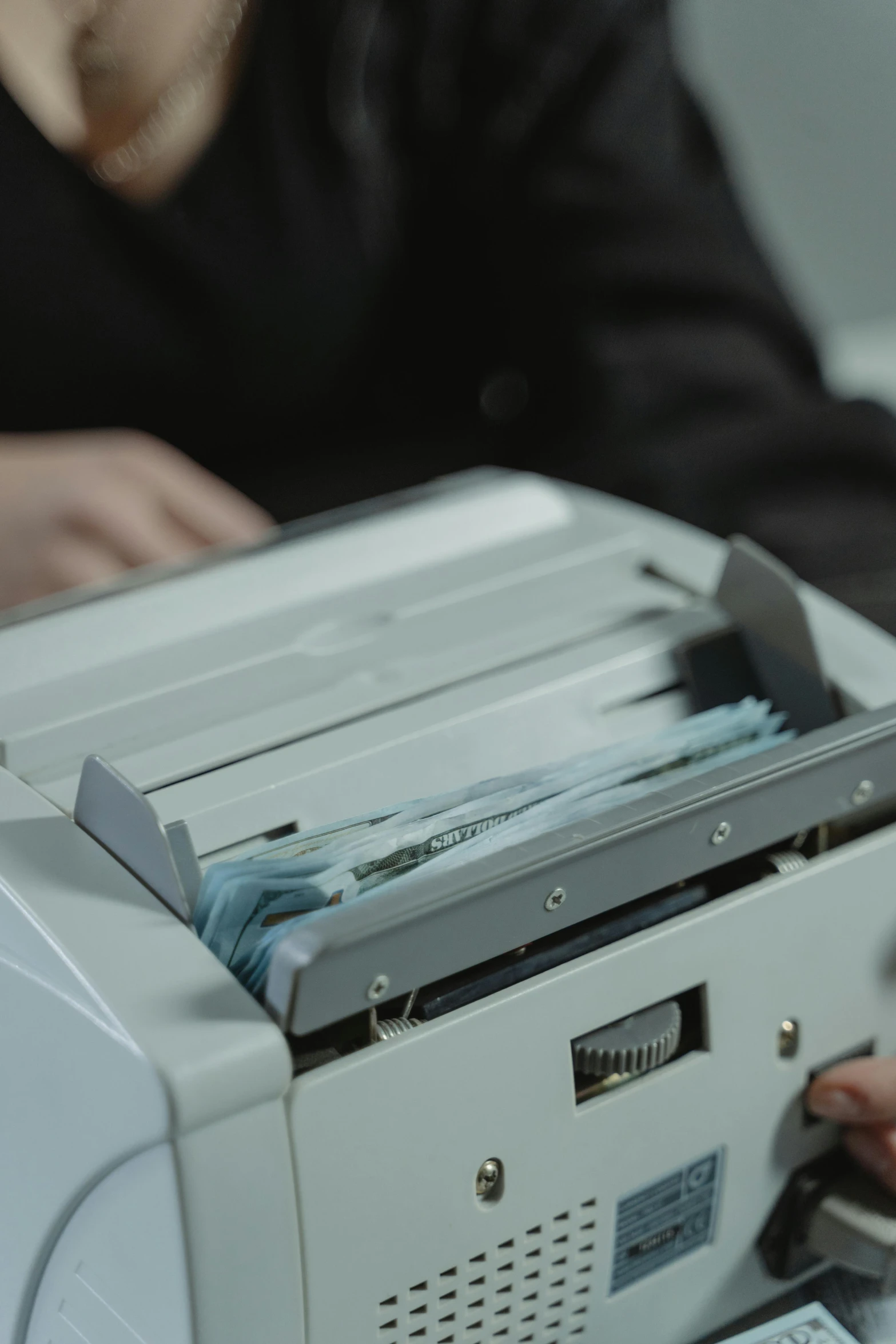 a close up of a person using a printer, open bank vault, low quality photo, gif, banknote