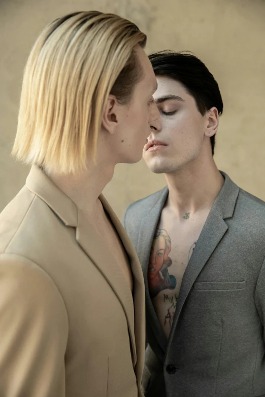 a couple of men standing next to each other, trending on pexels, bauhaus, reylo kissing, nonbinary model, editorial, johan liebert mixed with alucard