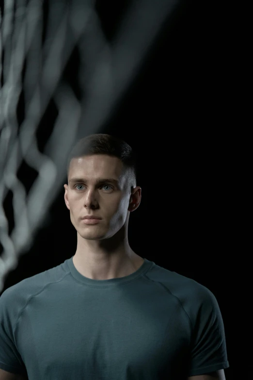 a man holding a tennis racquet in front of a net, a digital rendering, inspired by Jakub Husnik, trending on dribble, crew cut hair, nadav kander, standing with a black background, football