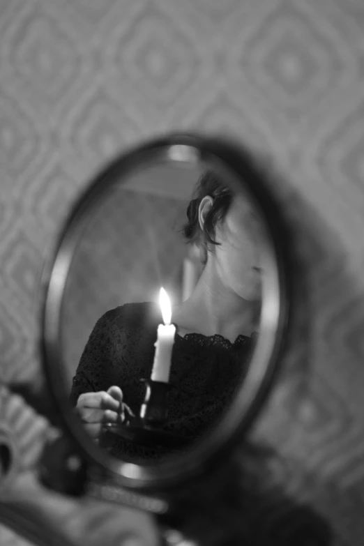 a person holding a candle in front of a mirror, a black and white photo, tumblr, sofya emelenko, lofi, ((portrait)), esthetic photo