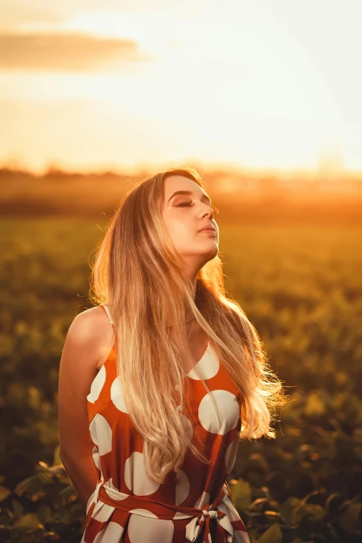 a woman standing in a field at sunset, pexels contest winner, blonde beautiful young woman, orange hue, young woman looking up, 5 0 0 px models