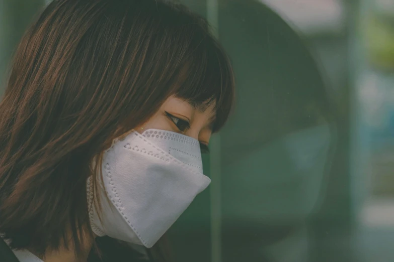 a close up of a person wearing a face mask, pexels contest winner, asian girl, from the side, desaturated, virus