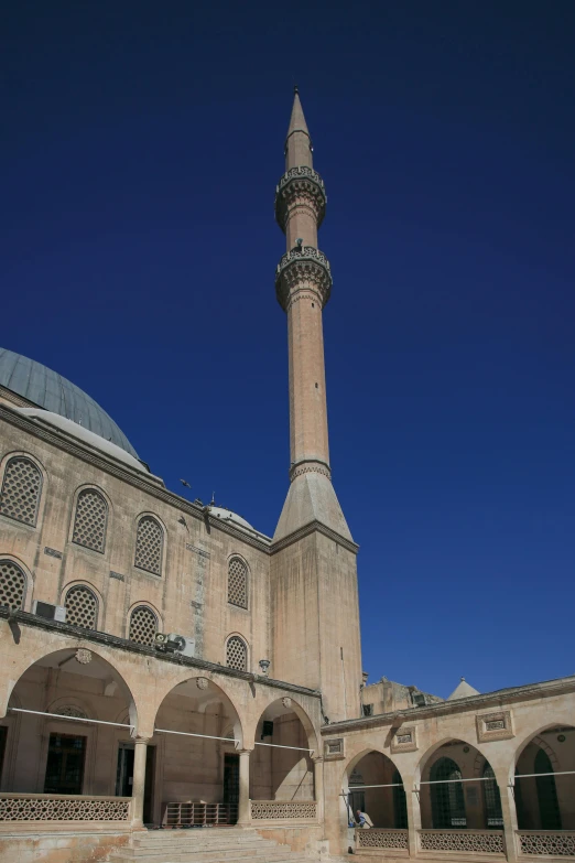 a very large building with a very tall tower, turkey, clear blue skies, lead - covered spire, colonnade